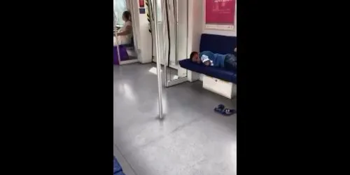 MRT passenger seen lying across multiple seats during journey - camel.000938