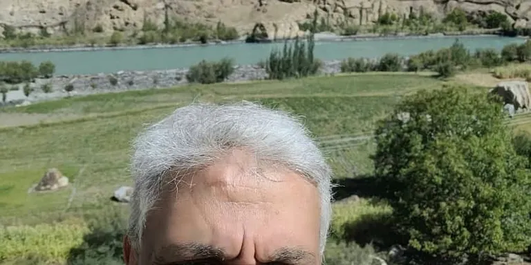 A nature's masterpiece where rugged mountains meet a sea of pink wildflowers, blooming in the heart of Gilgit-Baltistan