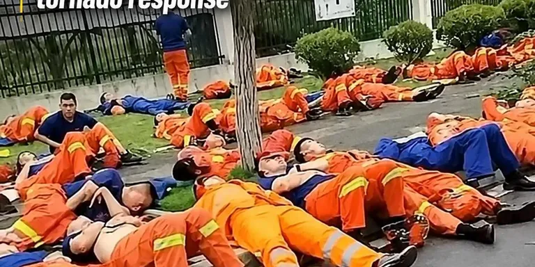 Exhausted firefighters rest on sidewalk after overnight tornado response